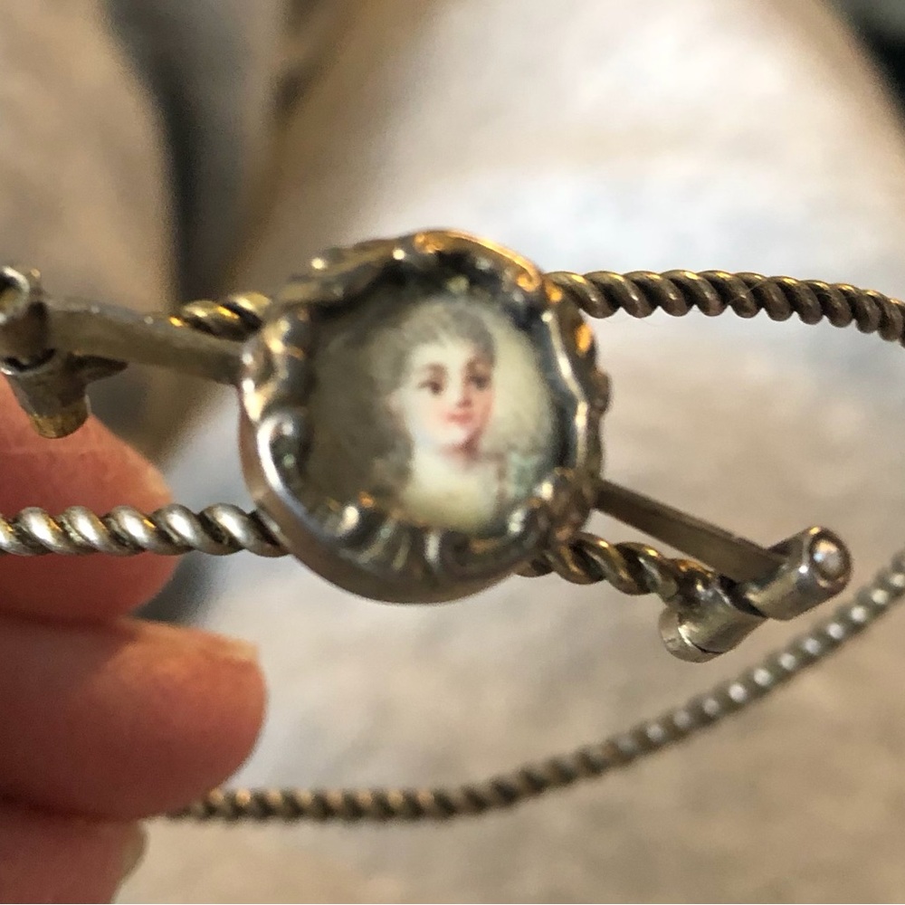 Antique goldtone bangle bracelet with small round portrait of a woman
